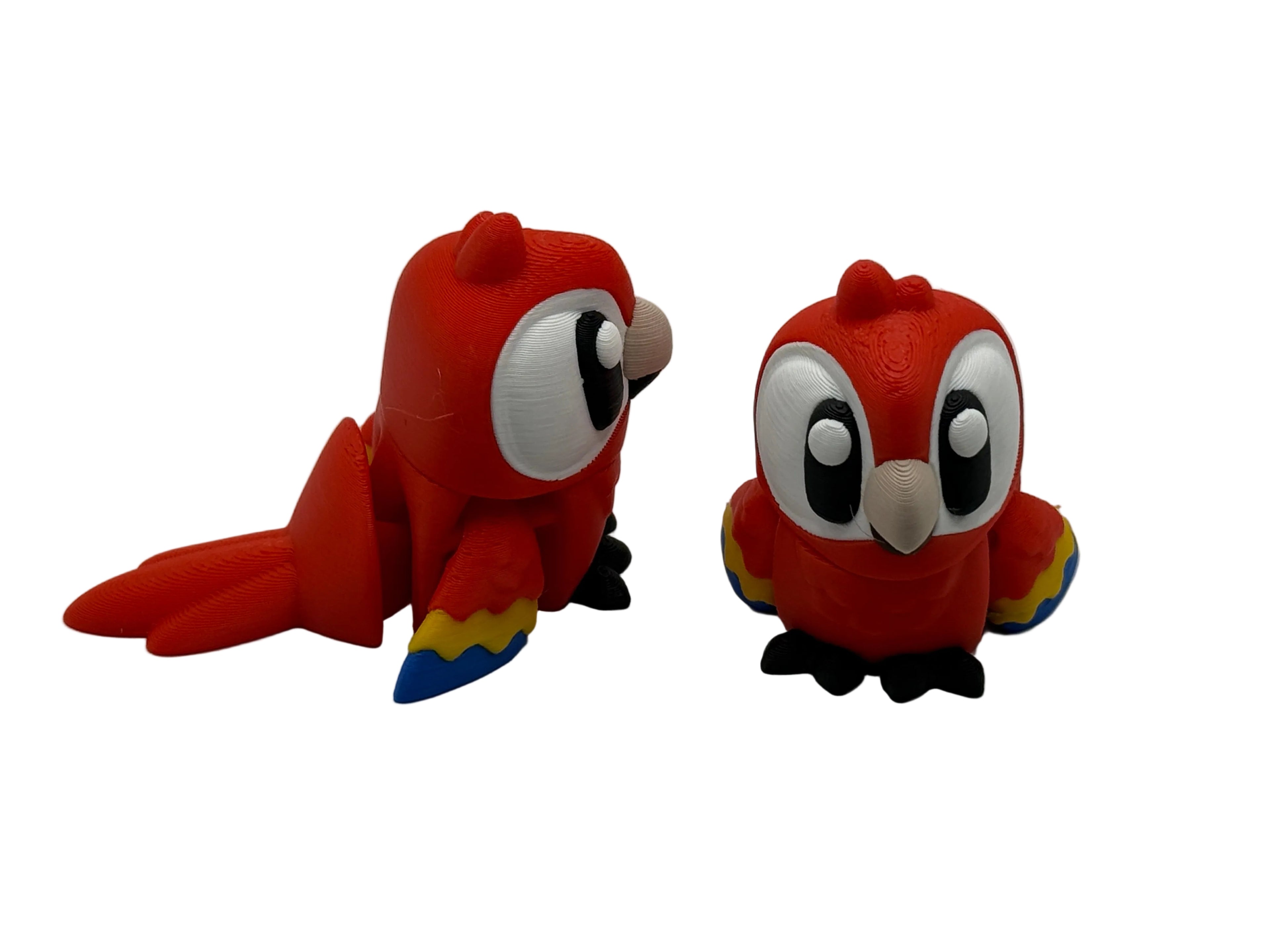 Two red parrot figurines on a white background