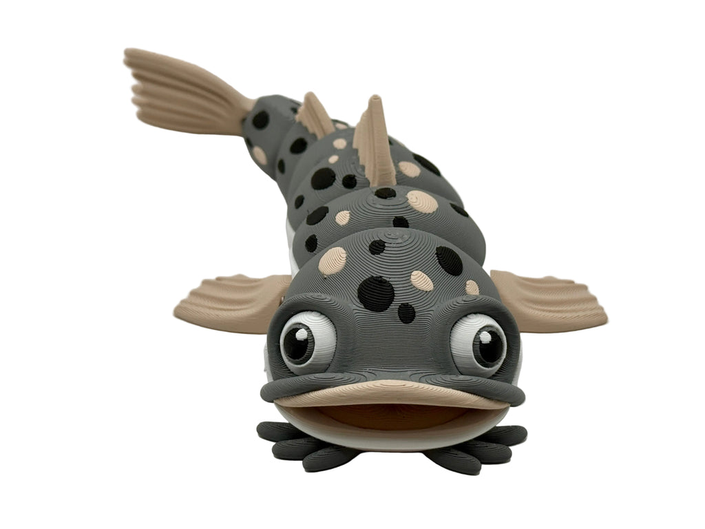 Toy catfish with polka dot pattern on a white background