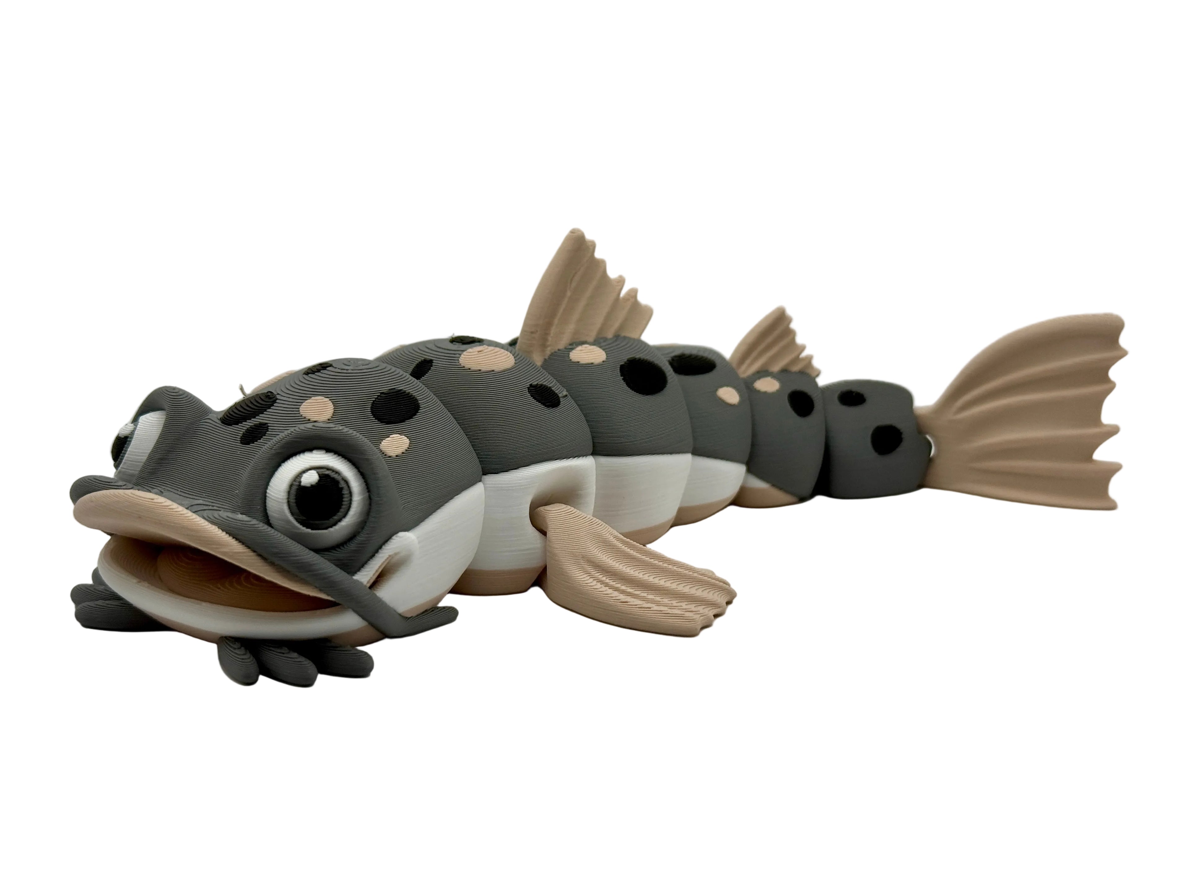 Gray and beige fish-shaped toy on a white background